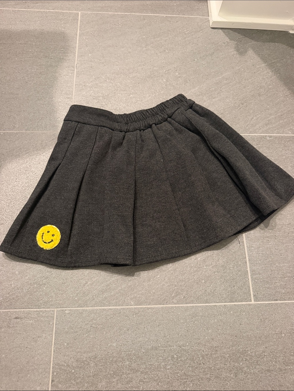 Lola + The Boys Charcoal Pleated Skirt with Yellow Smiley Patch